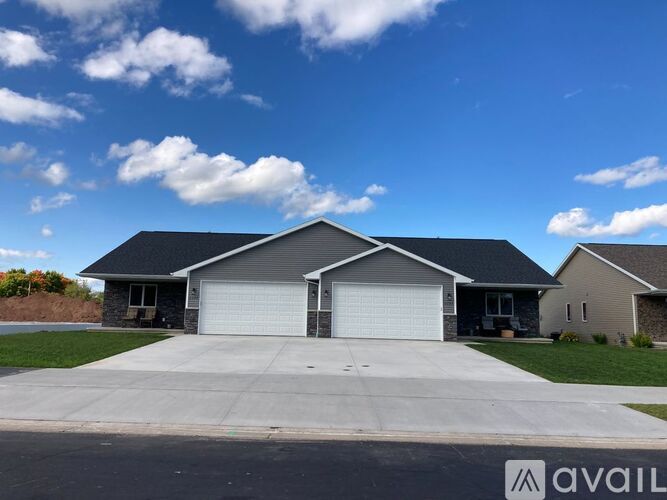 A two-story house with a garage is available for sale.