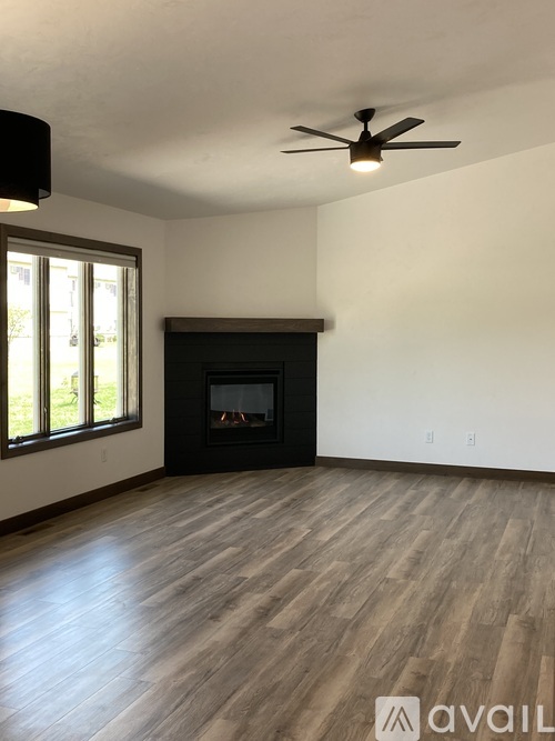 A room with a fireplace and a ceiling fan.