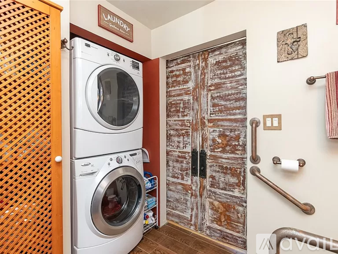 A washing machine is sitting in a laundry room.