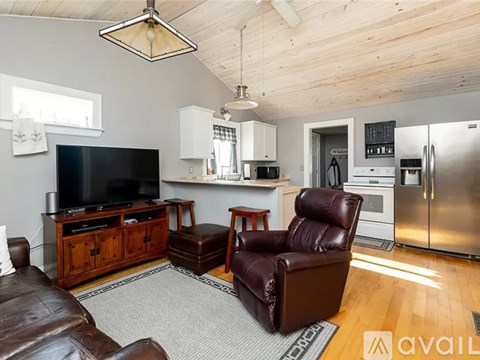 A living room with a brown leather chair and a television.