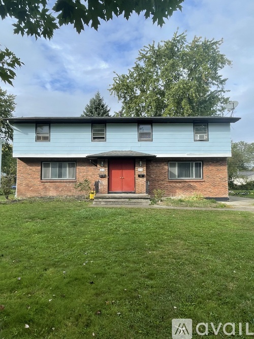 A house with a red door and a blue roof.