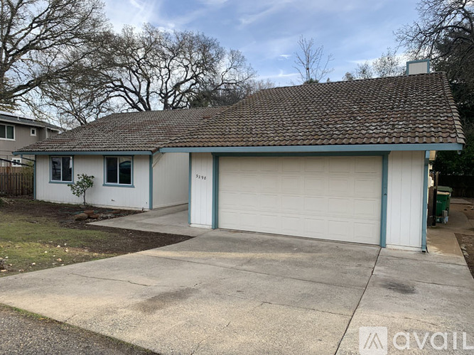 A two-car garage with a white exterior and a brown roof.
