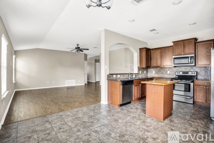 A kitchen with wooden cabinets and a central island.