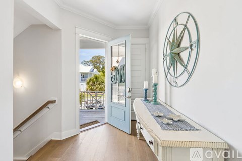 A bedroom with a large bed, a window, and a view of a deck.