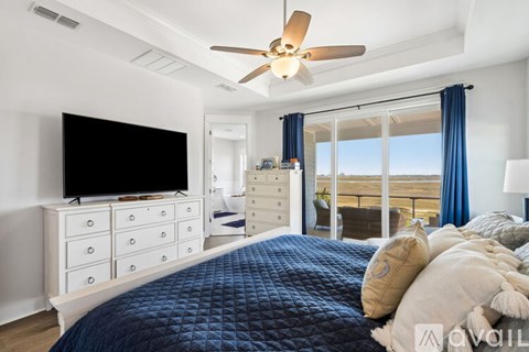 A bedroom with a large bed and a flat screen TV.