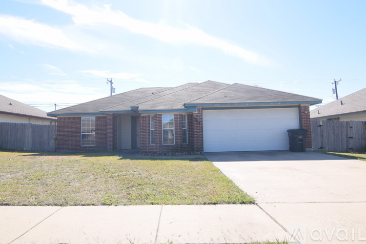 A house with a garage and a driveway in front.
