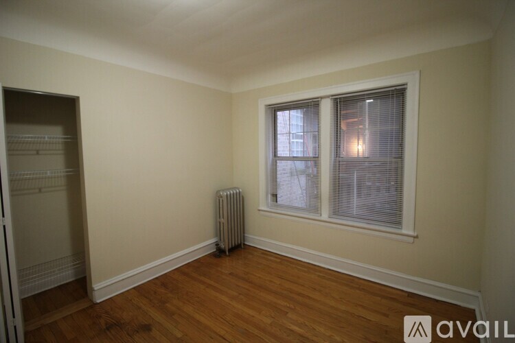 A room with a window and a radiator on the floor.