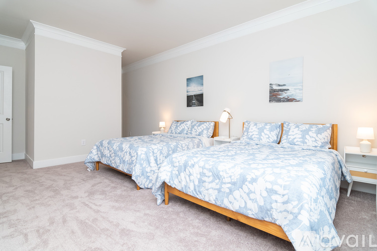 A bedroom with a bed and two lamps.