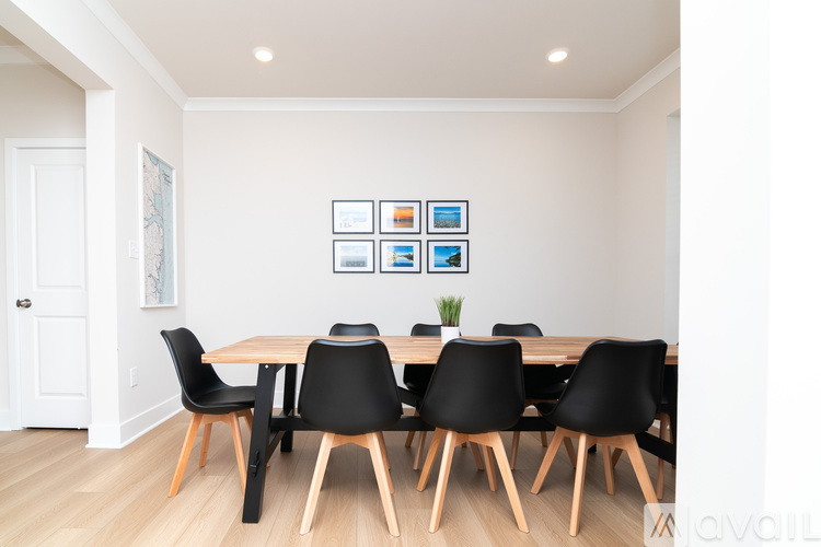 A dining room with a table and chairs.