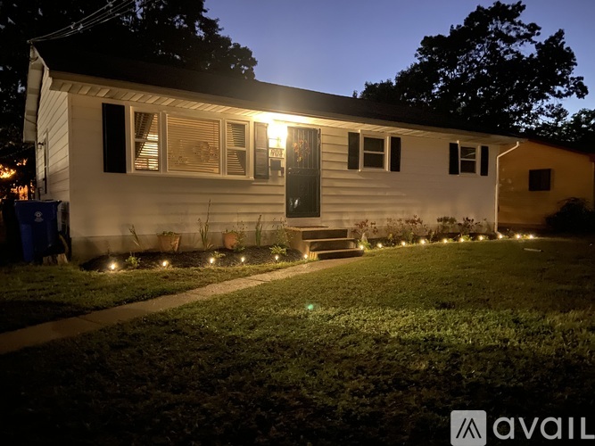 A house with lights on the front yard.