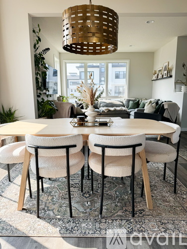 A dining room with a round table and chairs.
