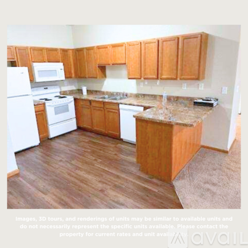 A kitchen with wooden cabinets and a granite countertop.