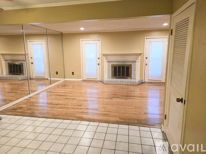 A room with wooden floors and white tiled floors.