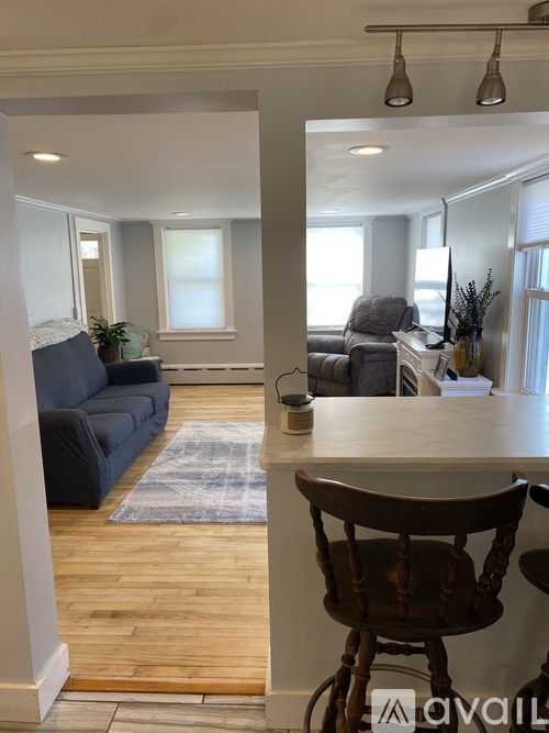 A living room with a grey couch and a wooden table.