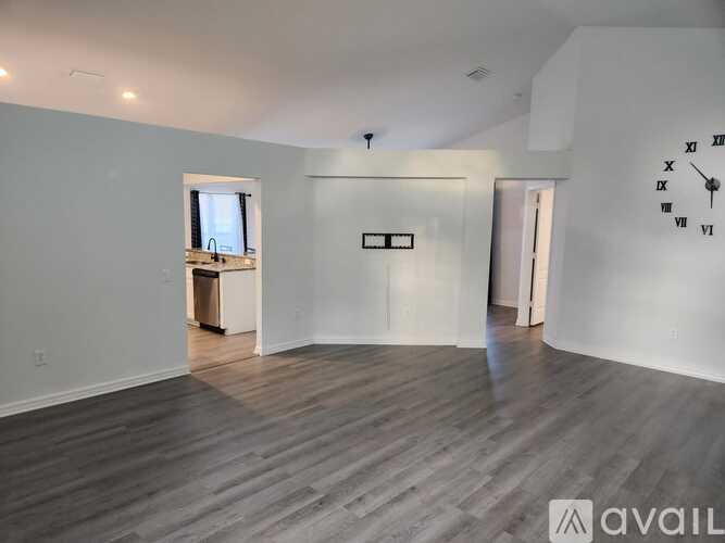 A large empty room with a clock on the wall.
