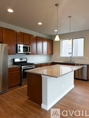 A kitchen with brown cabinets and a white island.