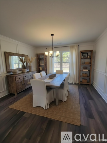 A dining room with a table set for four.