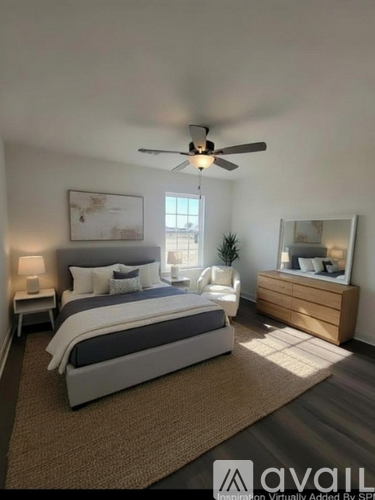 A bedroom with a bed, nightstand, and a ceiling fan.