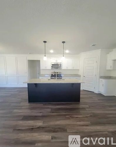 A kitchen with a large island in the middle.