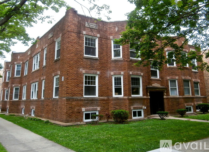 A red brick building with a black door and windows.