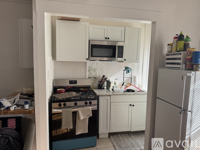 A kitchen with a stove, microwave, and refrigerator.