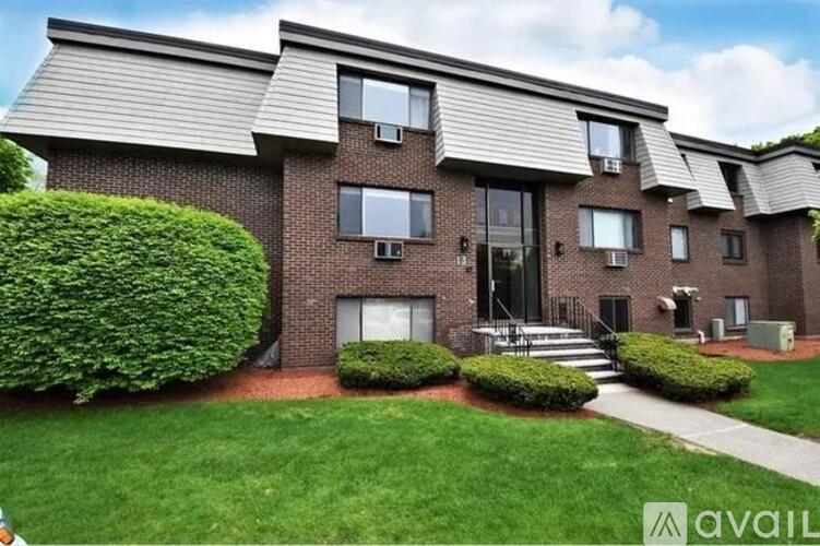 A modern brick house with a large front yard.