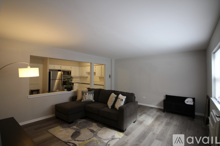 A living room with a couch, a lamp, and a television.