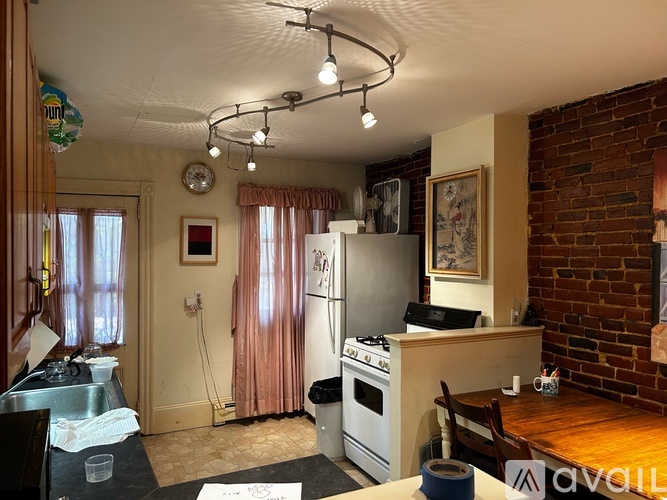 A kitchen with a stove, oven, and sink.