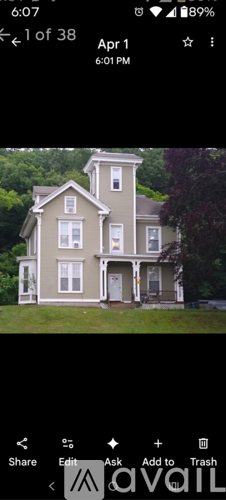 A two-story house with a grey facade and white trim.