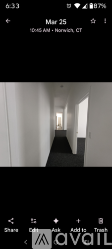 A long, narrow hallway with doors on both sides.