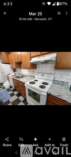 A kitchen with a black and white checkered floor.