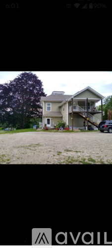 A house with a car parked in front.