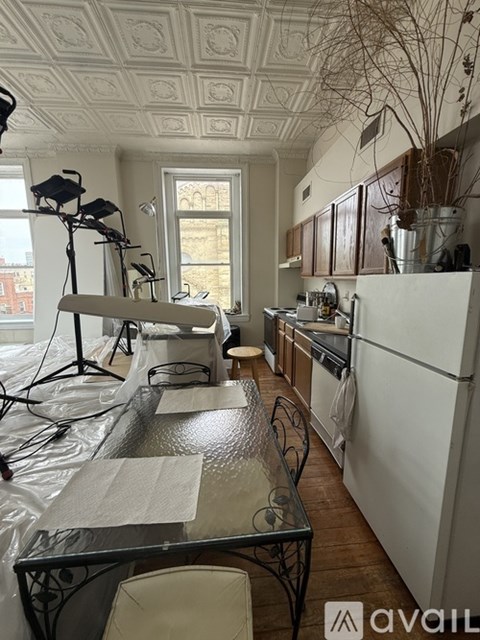A kitchen with a table and chairs in the middle of it.