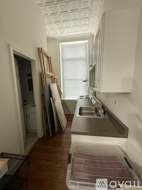 A kitchen with a sink and a window.
