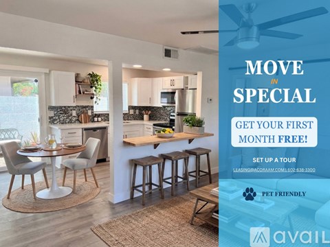 A modern kitchen with a dining table set up and a sign offering a free first month for a move in special.
