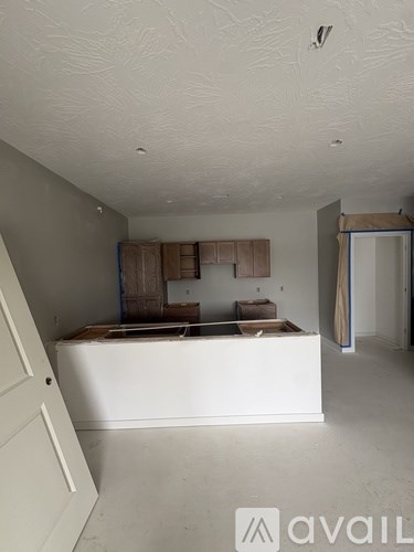 A room under construction with wooden framing and a window.