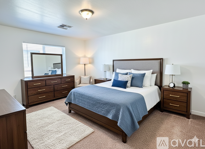 A bedroom with a bed, nightstand, and dresser.