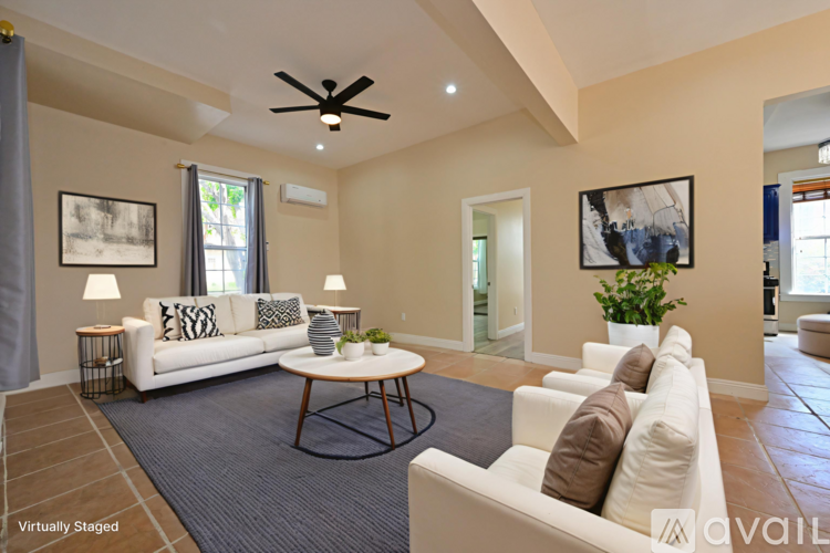 A living room with a white couch and a coffee table.