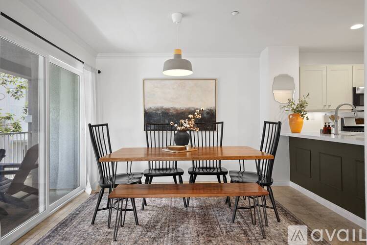 A dining room with a table set for four.