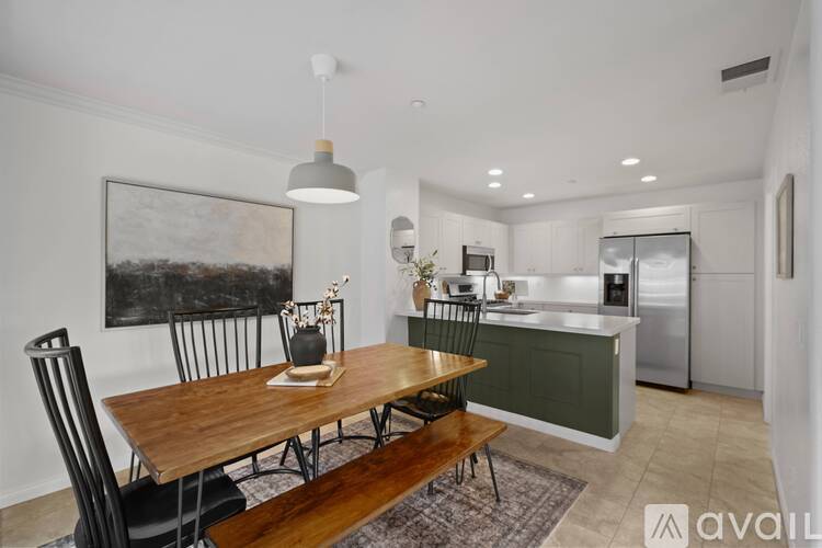 A modern kitchen with a dining table and chairs.