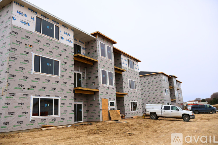 A building under construction with a white truck parked in front.