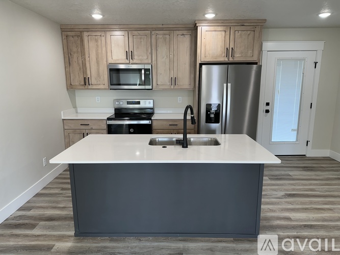A kitchen with a white countertop and a refrigerator.