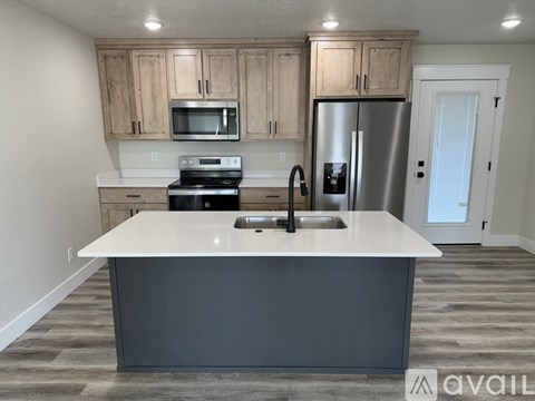 A kitchen with a white countertop and a refrigerator.