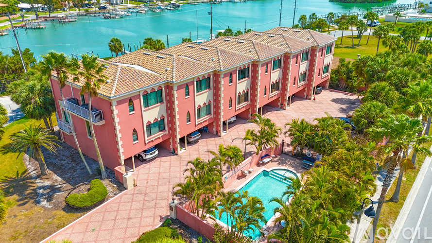A red building with a pool in front of it.