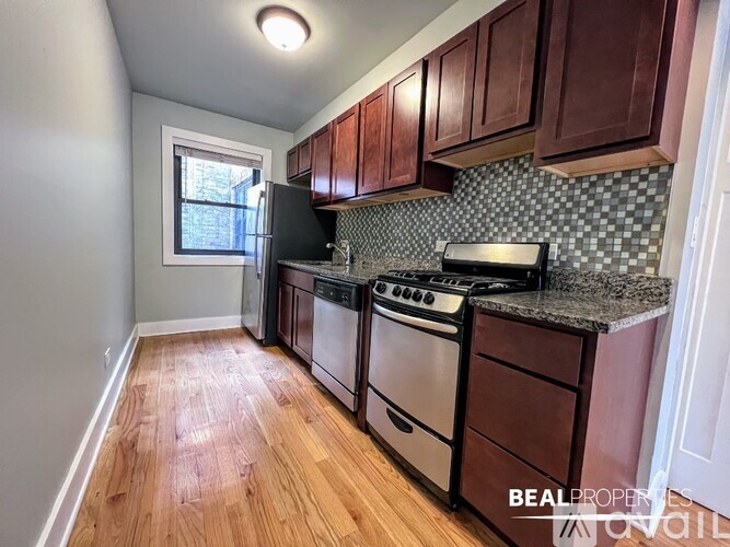 A kitchen with wooden cabinets and a black stove top oven.