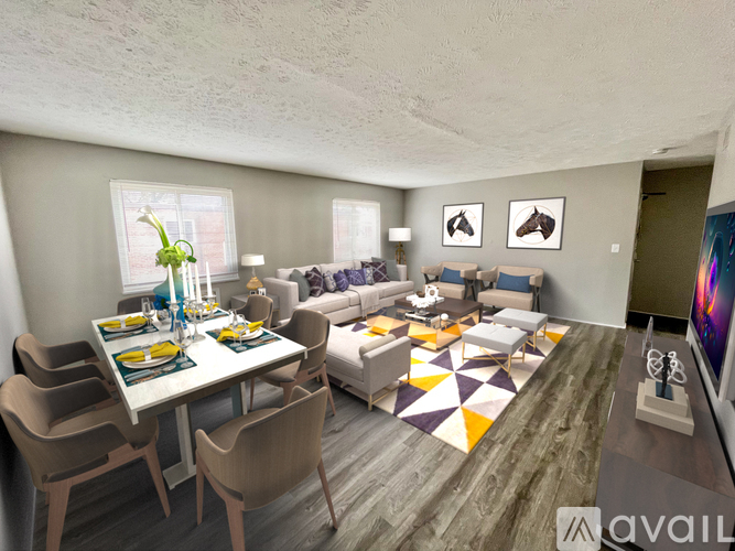 A living room with a dining table set for two and a couch.
