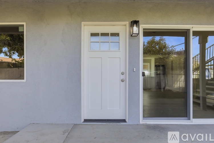 A white door with a glass window is on the right side of the image.
