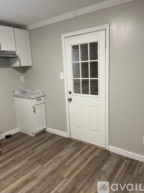 A small room with a door and a cabinet.