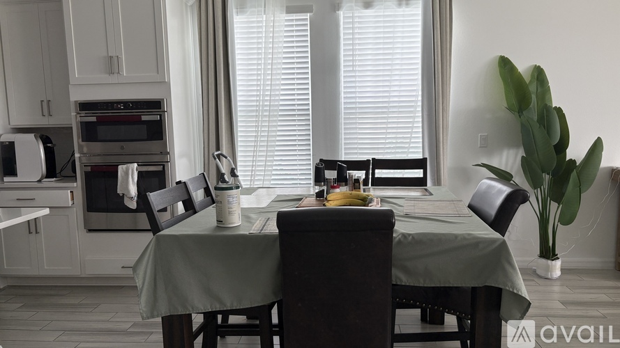 A kitchen with a table set for four.