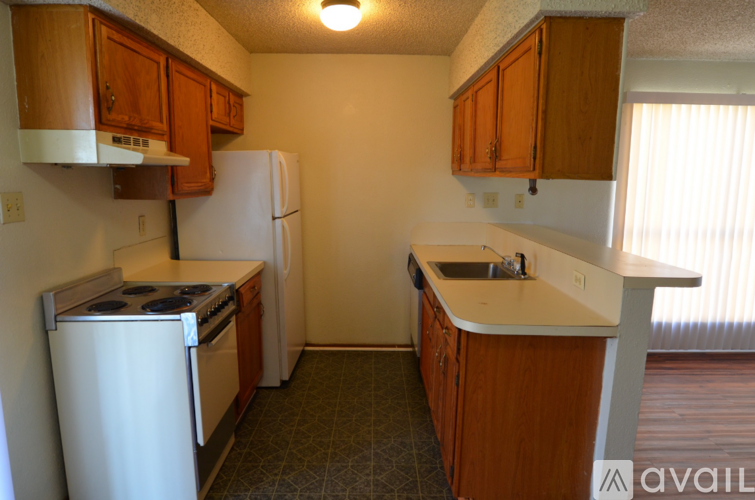 A kitchen with a white refrigerator and a white stove.